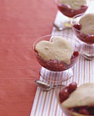 Cherry dessert with heart-shaped biscuit