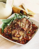 Pork Cutlets With a Tomato Vegetable Sauce in a Square Bowl