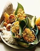 Curry Rice Wrapped in Banana Leaves Surrounded by Fresh Ingredients