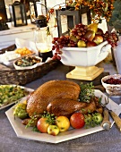 Thanksgiving Buffet with Roast Turkey on a Platter with Fruit; Fruit Centerpiece and Side Dishes