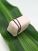 White chocolate confection on a leaf