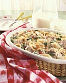 Tuna Noodle Casserole with Broccoli in Baking Dish; Pitcher and Glass of Milk