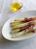 Platter of White Asparagus Wrapped in Prosciutto and Drizzled with Olive Oil