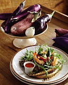 Grilled aubergines with salad leaves and shrimps