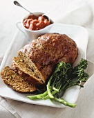 Meatloaf on a Platter with Broccoli and Tomato Sauce