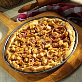 American pizza with barbecued chicken and onion rings