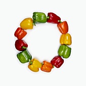 Red, yellow and green peppers, arranged in a circle