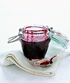 Homemade Red Currant Jelly in Canning Jar and on Spoon