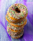 Six Glazed Donuts with Sprinkles Stacked on Each Other