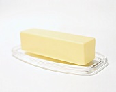 Stick of butter on glass dish