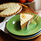 A piece of pumpkin mousse pie in front of pie, piece taken (USA)