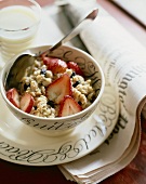Bowl of Oatmeal with Raisins and Fresh Strawberries; Spoon