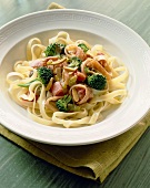 White Bowl of Fettuccini with Broccoli and Golden Raisins