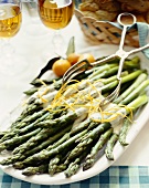 Platter of Asparagus with Cream Sauce and Orange Zest; Tongs