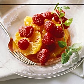 Raspberry and Orange Fruit Salad in a Glass Bowl with Mint Garnish