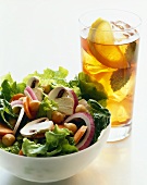 Bowl of Chopped Salad with a Glass of Iced Tea