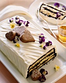Chocolate and Cream Layer Cake with Chocolate Heart Decorations; Sliced