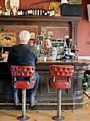 Man chatting with landlord in a pub