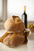 Two Loaves of Pain de Campagne in Brown Bag, Wine Bottle