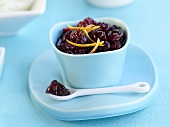 Cranberry sauce with orange zest in small bowl & on spoon