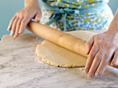 Hands rolling out pastry