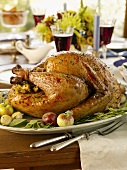Roast stuffed turkey on laid table (USA)