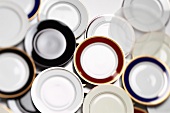 Many different plates, some with gold rim