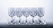 Empty wine glasses in rows on tray