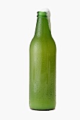 Beer frothing out of green bottle