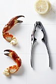 Two Crab Claws with Lobster Cracker and Lemon Half