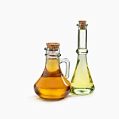 Two Bottles of Assorted Oils on a White Background