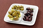 Three Assorted Olives on a White Platter