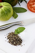 Small Pile of Spice Mixture with Basil Sprig and a Knife, Tomatoes