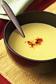 Bowl of Creamy Corn Soup with Cayenne Pepper Garnish, Spoon