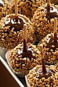 Toffee apples coated in chopped nuts