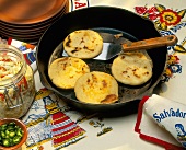 Pupusas in a Frying Pan with a Spatula