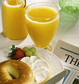 Bagel with Cream Cheese and a Glass of Orange Juice