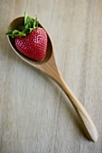 A Single Strawberry in a Wooden Spoon