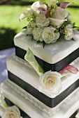 Three Tiered Wedding Cake Decorated with Roses and Calla Lilies