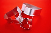 Heart Shaped Cookie Cutters on a Red Background