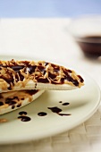 Banana Halves Drizzled with Chocolate and Peanut Butter on a Plate