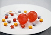 Two Lollipops with Colorful Candies on a Plate