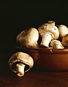 Button Mushrooms in and Beside a Chipped Bowl