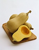 Butternut Squash on a Wooden Board: Two Whole, One Half
