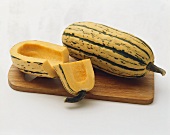 Delicata Squash on a Wooden Board: Halved and Whole