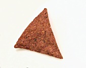 A Single Taco Flavored Tortilla Chip on a White Background