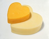 A Piece of Orange and a Piece of White Cheddar Cheese in the Shape of Hearts