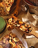 Trail Mix in a Wooden Scoop and in a Plastic Bag on Wooden Table with Map and Canteen