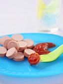 Sliced Hot Dog on a Plate, Slice on a Fork with Ketchup