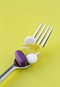 Assorted Vitamins on a Fork
